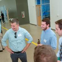 Guests looking at a poster board for a machine design
